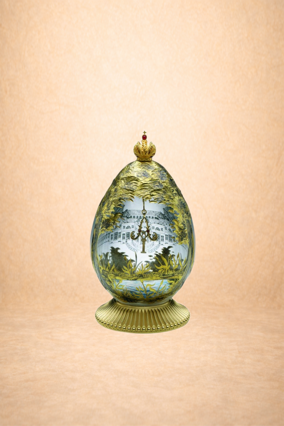 Decorative egg-shaped ornament with a gold crown on top, featuring a painted scene of a building, trees, and a chandelier, set on a gold base against a light peach background.