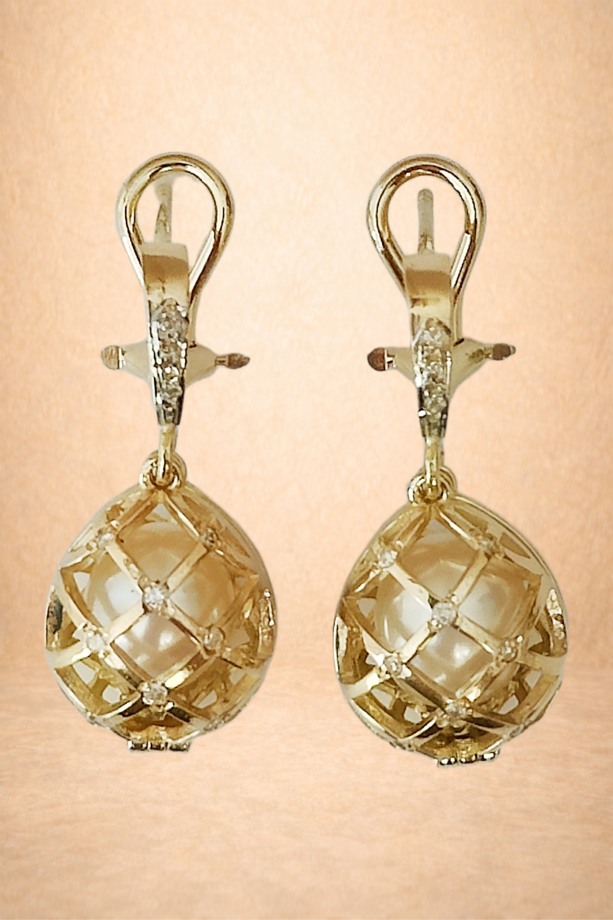 A pair of gold earrings with lattice design and small embedded diamonds.