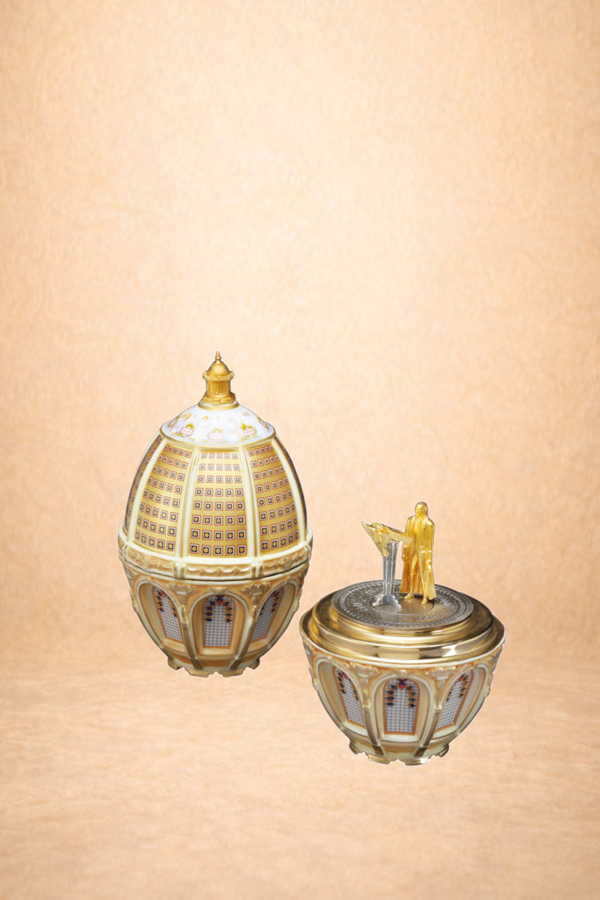 Two ornate decorative lamps with gold accents and figurines on top, set against a plain beige background.