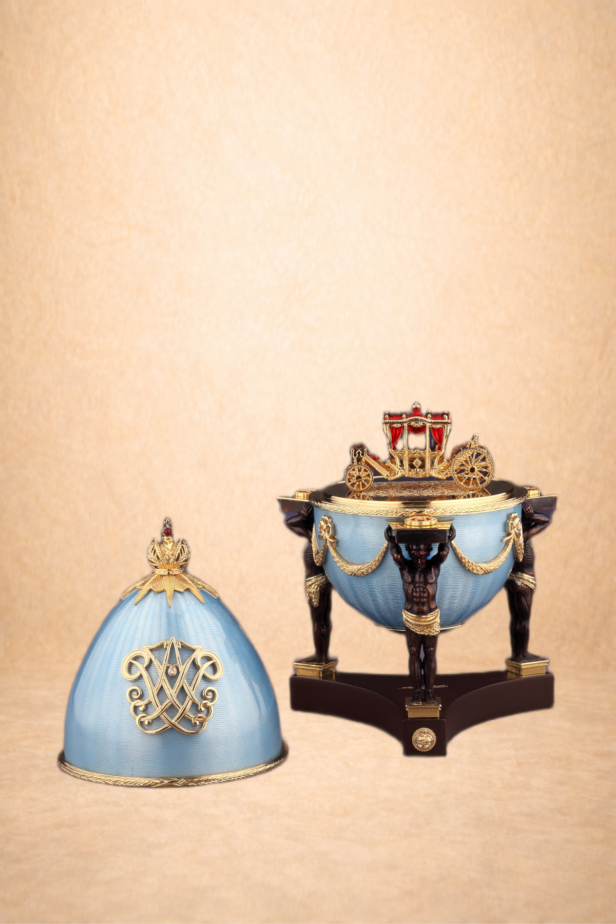 Decorative royal crown and tiara with blue and gold accents, displayed on a beige background.
