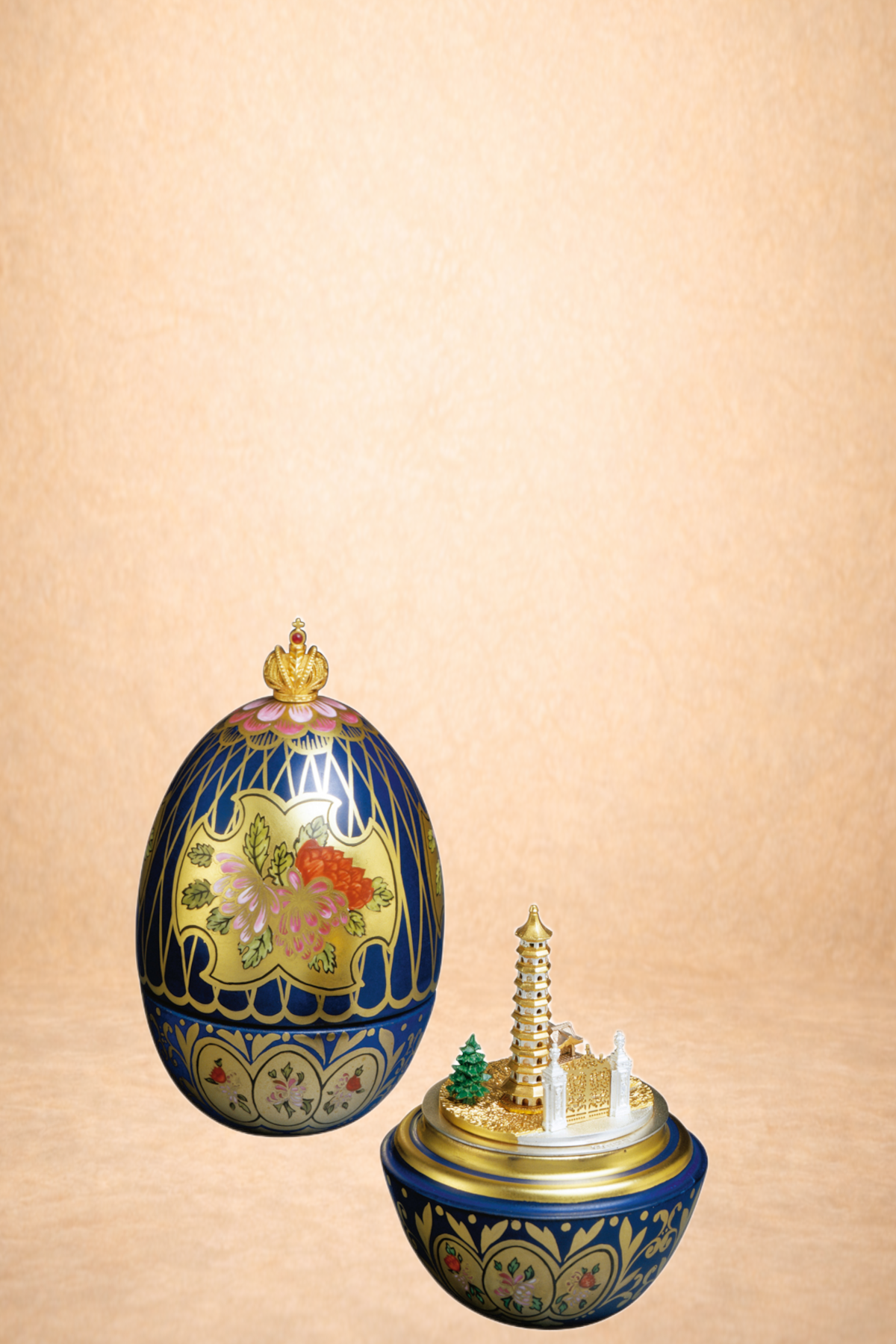Decorative Easter egg with floral and geometric designs, topped with a gold crown, and a miniature Asian-style pagoda and trees on a gold and blue base.