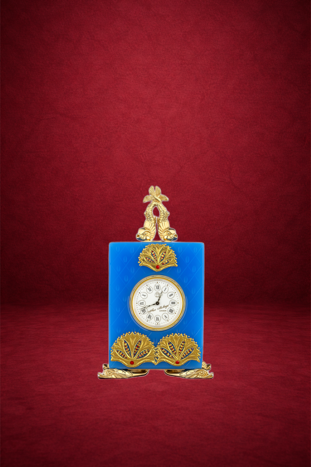 A vintage-style clock painted in bright blue with gold accents, set against a red textured background.