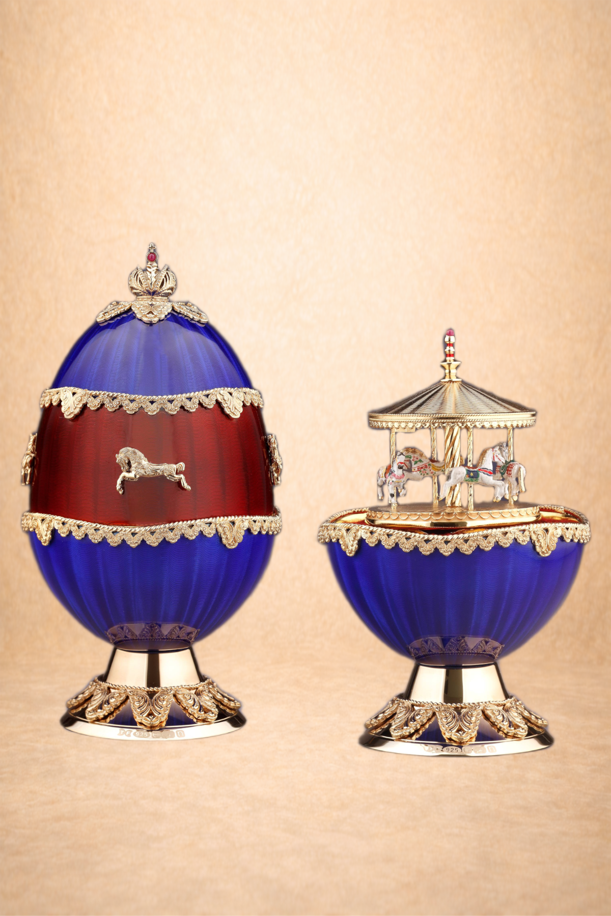 Decorative egg-shaped container and a carousel music box, both with blue, red, and gold embellishments, against a beige background.