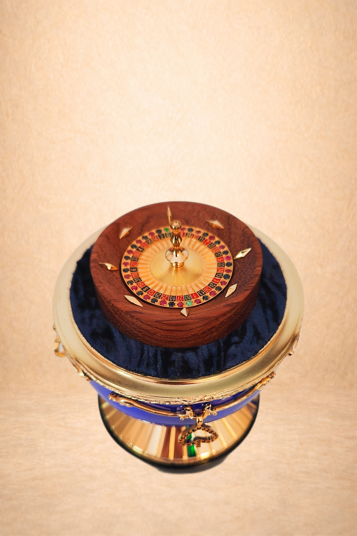 Close-up of a roulette wheel with a wooden top, a circular numbered betting area, and a small ball on it, on a velvet cushion and a reflective surface.