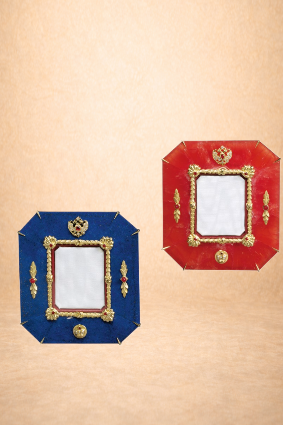 Two decorative picture frames, one blue and one red, with gold accents and ornate designs, mounted on a beige background.