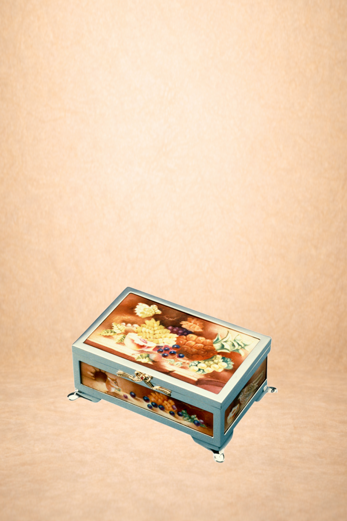 A vintage jewelry box with a floral and fruit design on the lid, standing on four decorative legs against a peach-colored background.