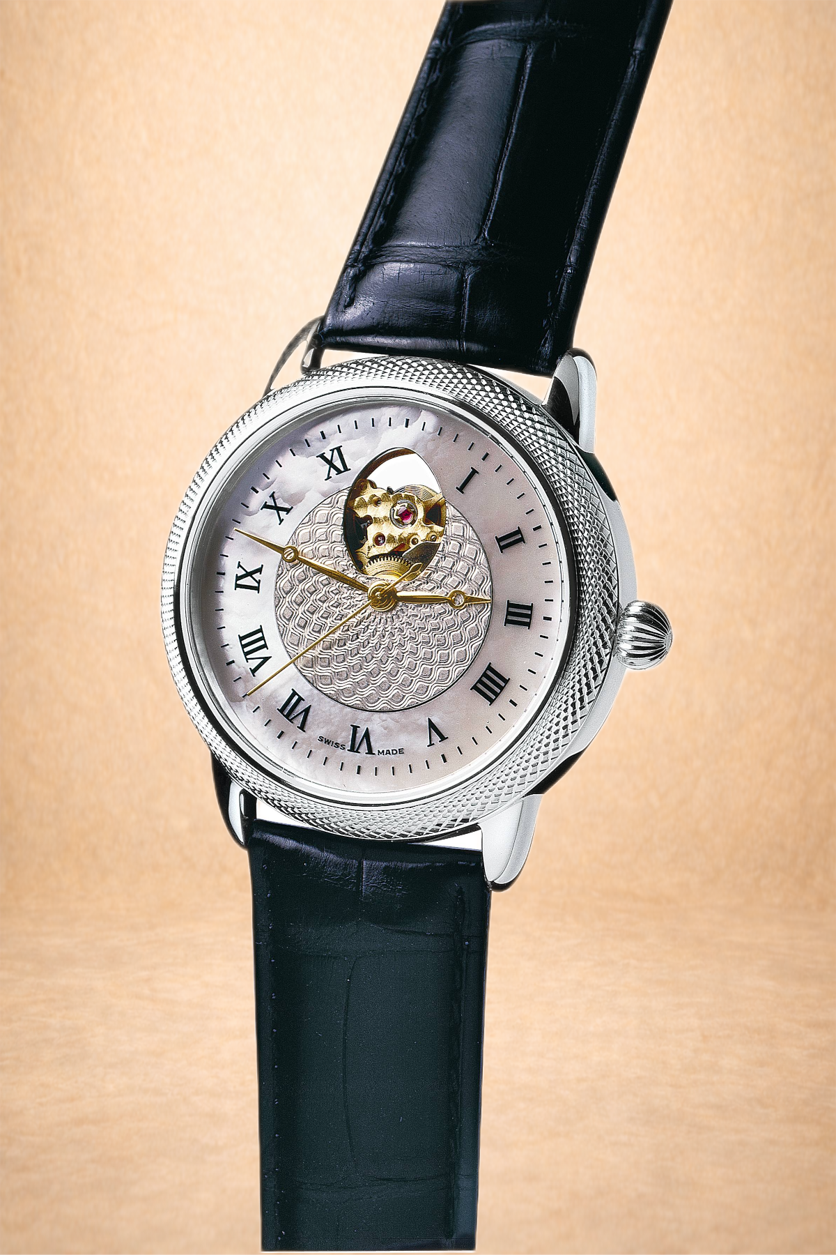 Close-up of a luxury wristwatch with a black leather strap, silver watch face with Roman numerals, and visible mechanical movement at the top center.