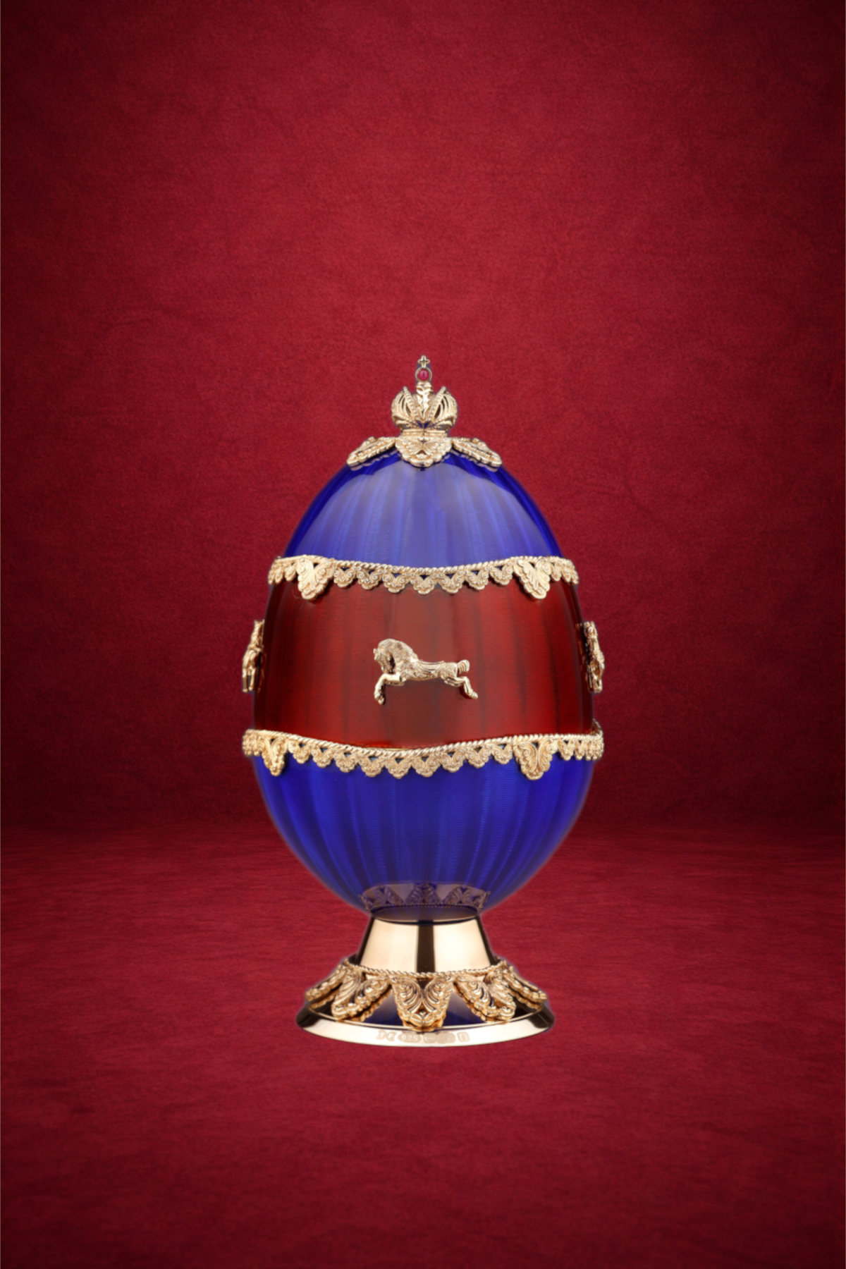 Carousel egg creation by Theo Fabergé inspired by traditional fairground carousel imagery crafted in gold and enamel.