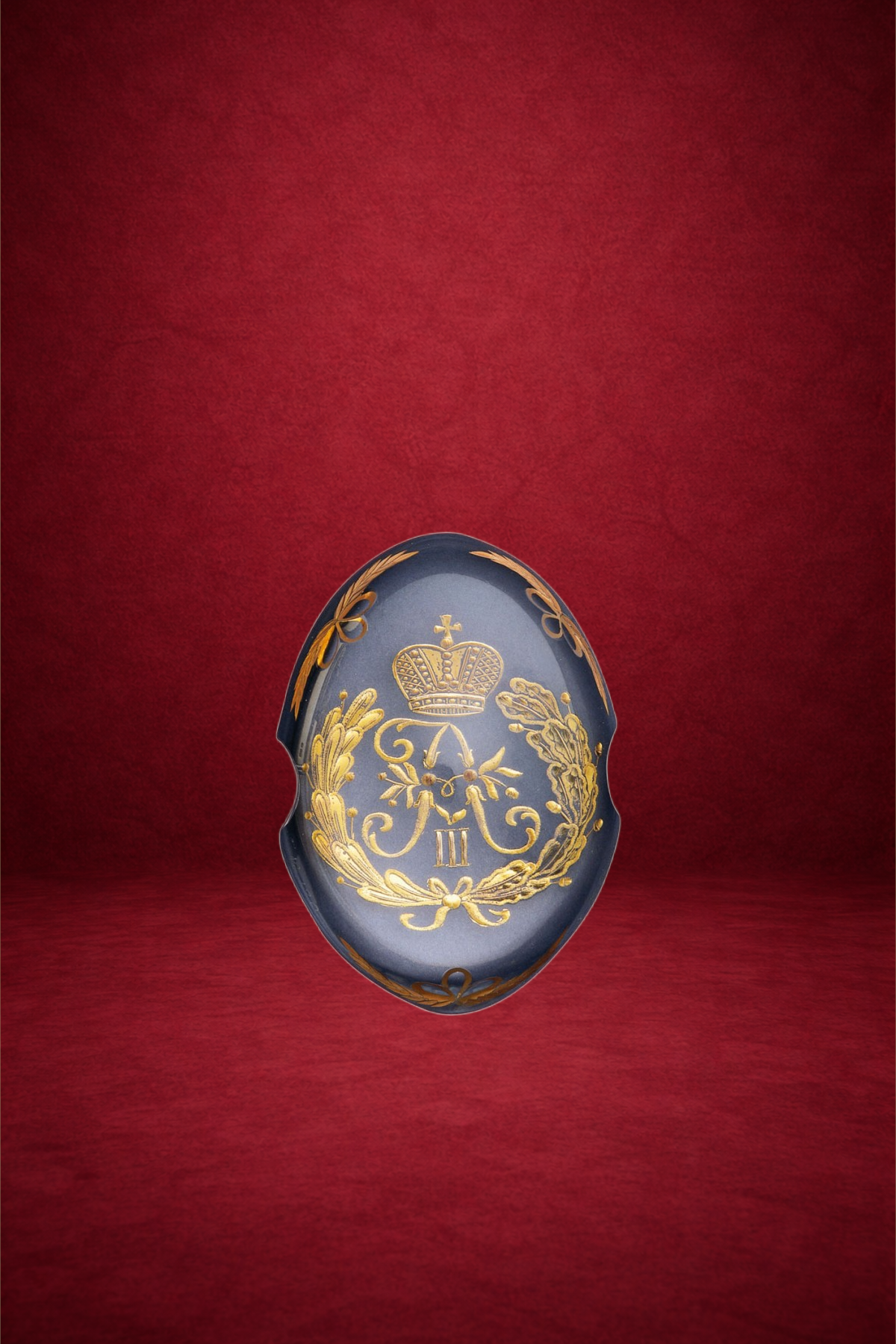 A ceramic egg with gold royal insignia, including a crown and laurel wreath, set against a red background.