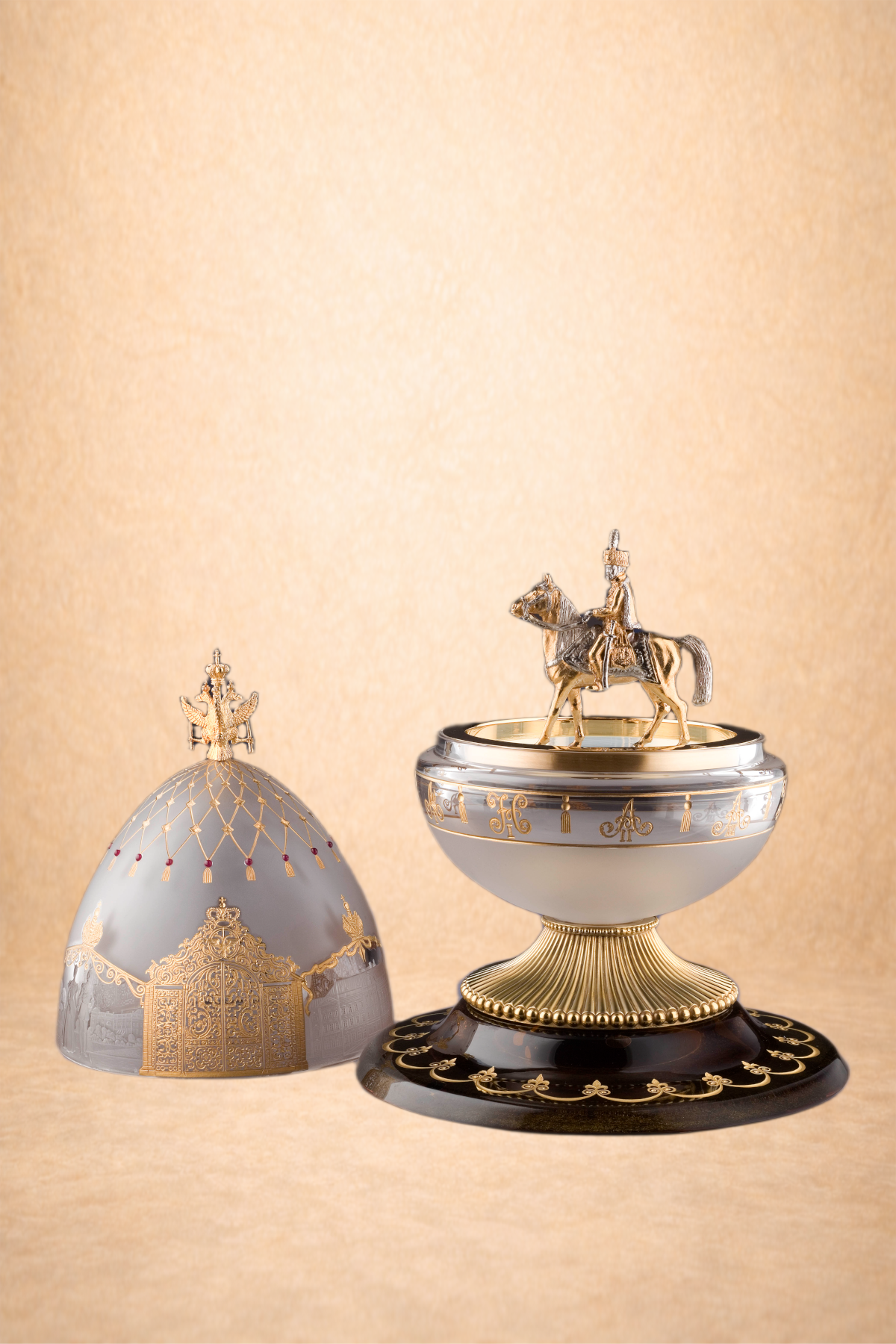 Decorative gold and white royal crown with a miniature gold horse and rider figurine on top, placed on a black and gold base, with a beige textured background.