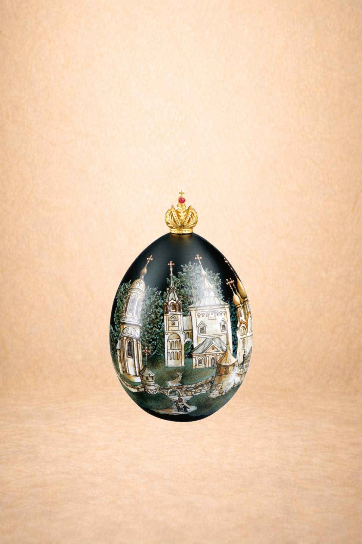 A decorative egg with a black background, featuring a detailed painting of a church and trees, topped with a gold crown with red accents.