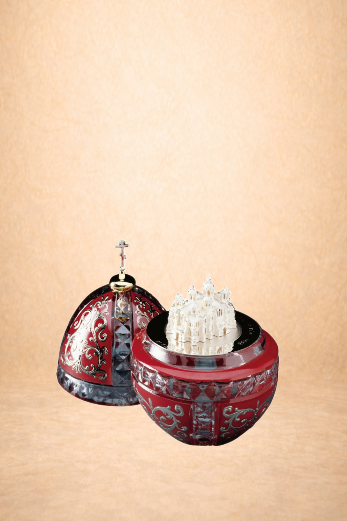 Decorative red and silver jewelry boxes with miniature white church and castle figurines on top, set against a beige background.