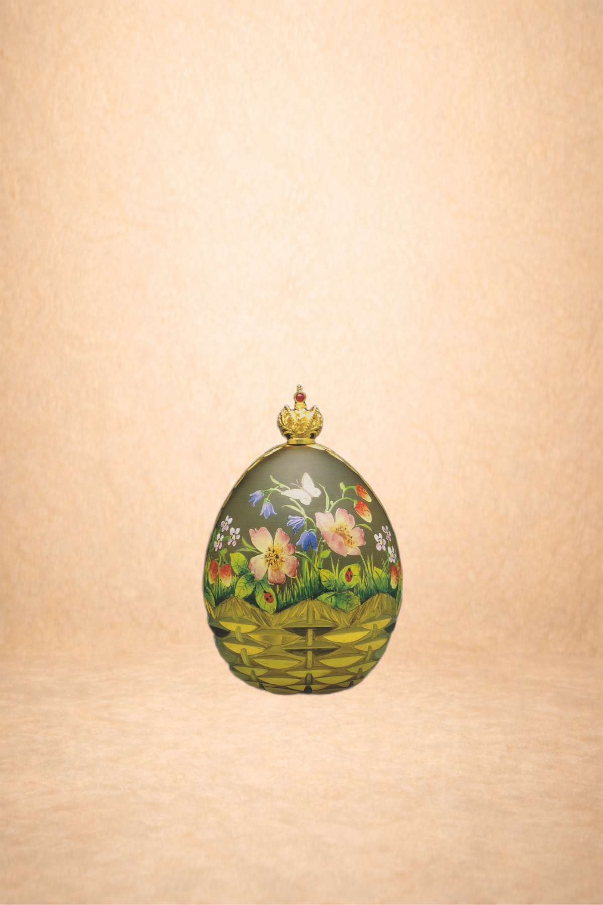 Decorative egg with floral and nesting bird design, topped with a small crown-shaped ornament, set against a light background.