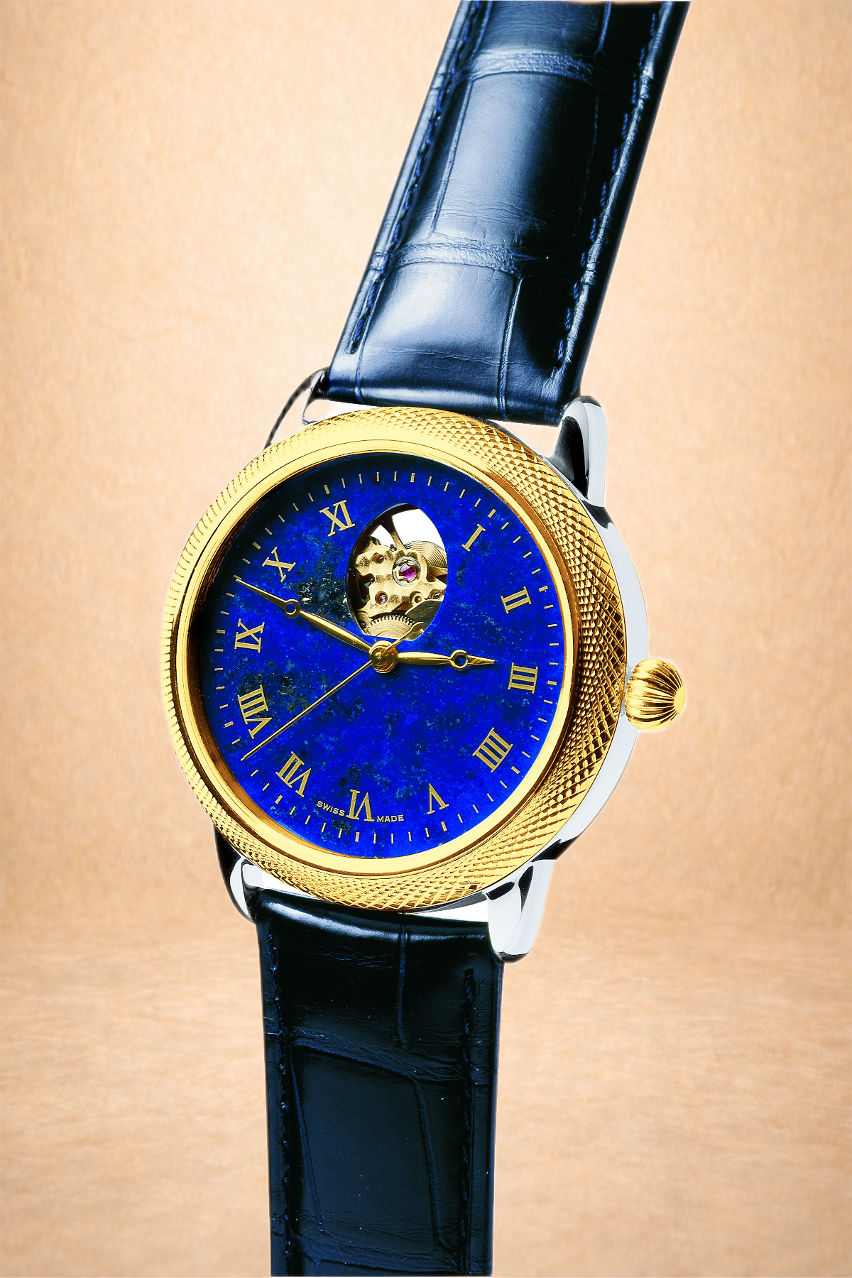 A luxury wristwatch with a blue face, gold bezel, and black leather strap.