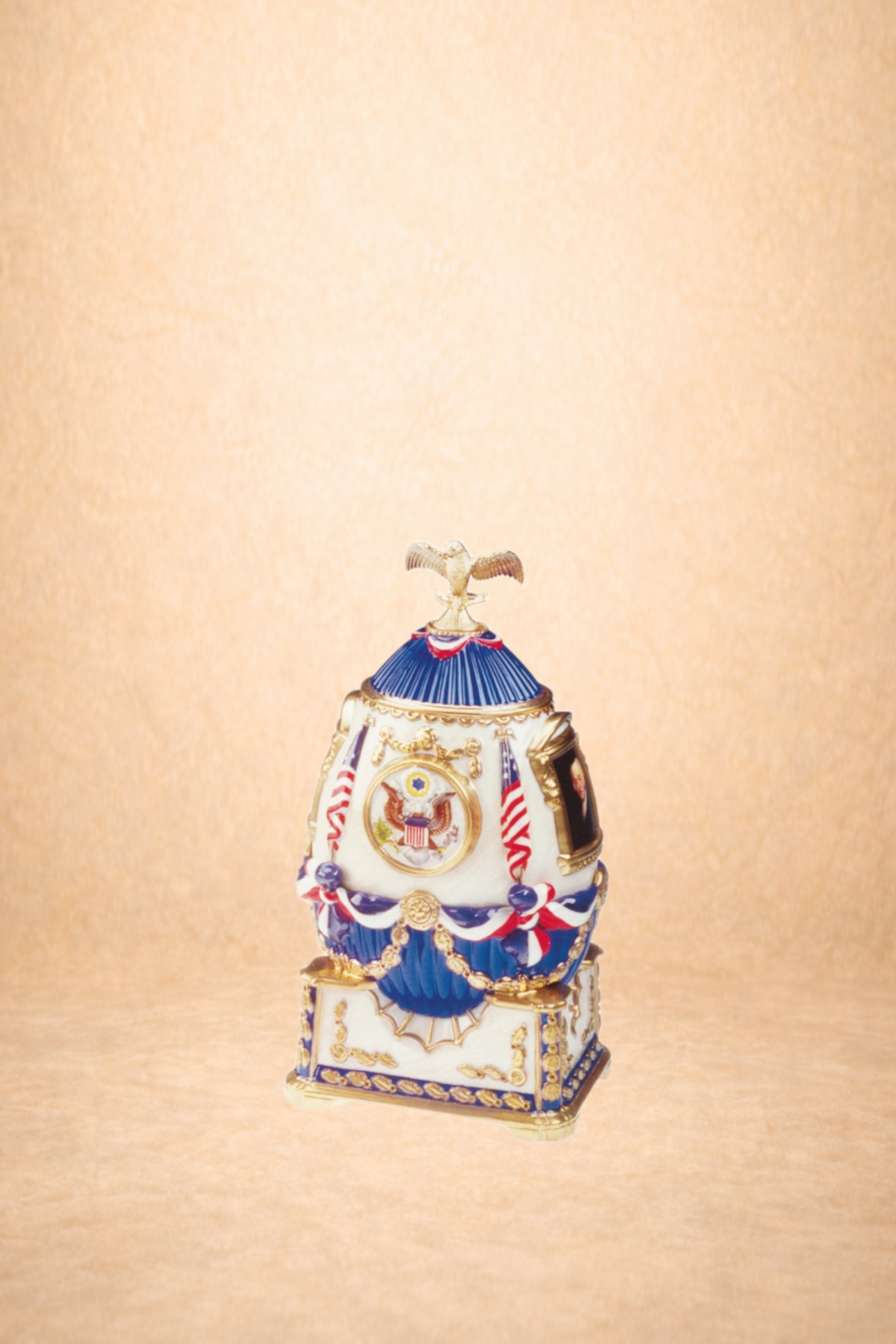 A porcelain decorative container with patriotic American symbolism, including an eagle, stars, and American flags, decorated with blue, white, and red accents.