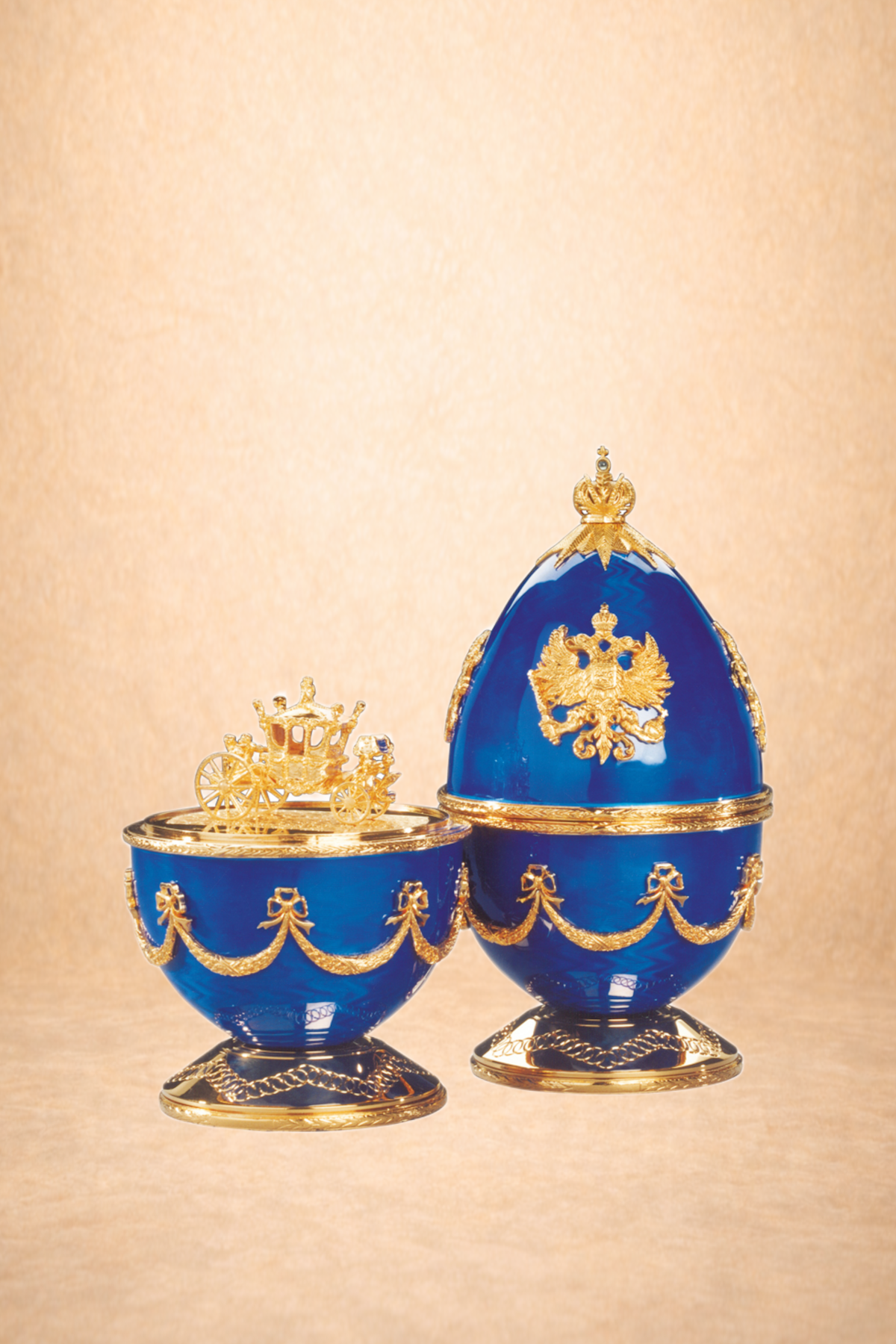 Decorative blue and gold Fabergé-style Easter eggs with ornate details and royal symbols.