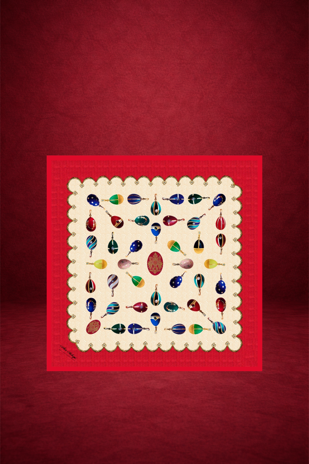 A square handkerchief with a scalloped border, featuring hand-painted glass Christmas ornaments arranged in a grid pattern with a red and gold design in the center. The handkerchief is placed on a red background.