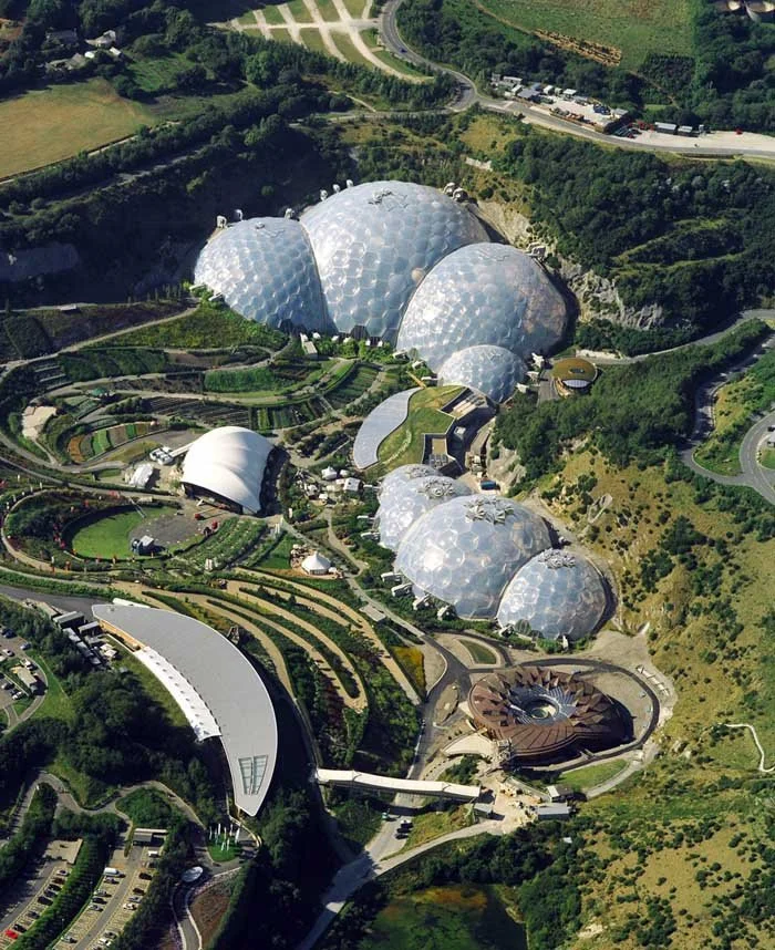 Aerial view of the Getty Center in Los Angeles with several interconnected metallic and glass domes, designed as modern architectural structures for art exhibits and gardens.