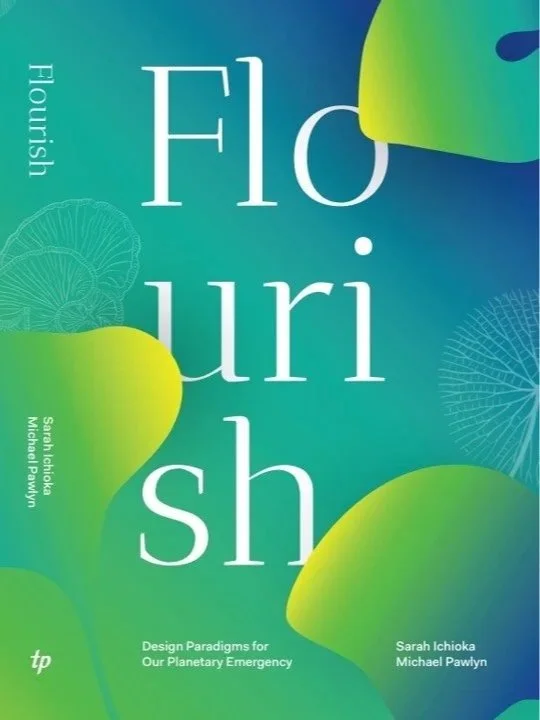 A book cover titled "Flourish" with a subtitle "Design Paradigms for Our Planetary Emergency." The authors are Sarah Ichioka and Michael Pawlyn. The design features a colorful, abstract background with green and blue hues and illustrations of plant leaves.