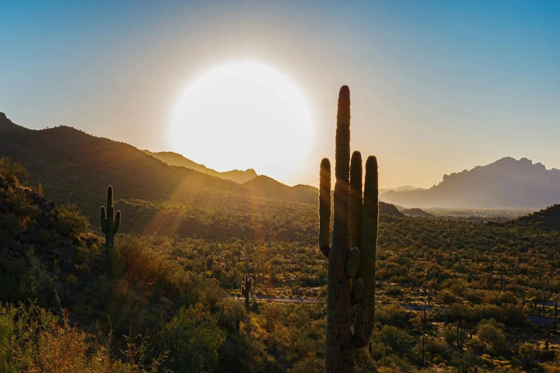 Desert sunrise over a southwestern mountain landscape with warm golden light, representing intentional living and clarity in midlife.