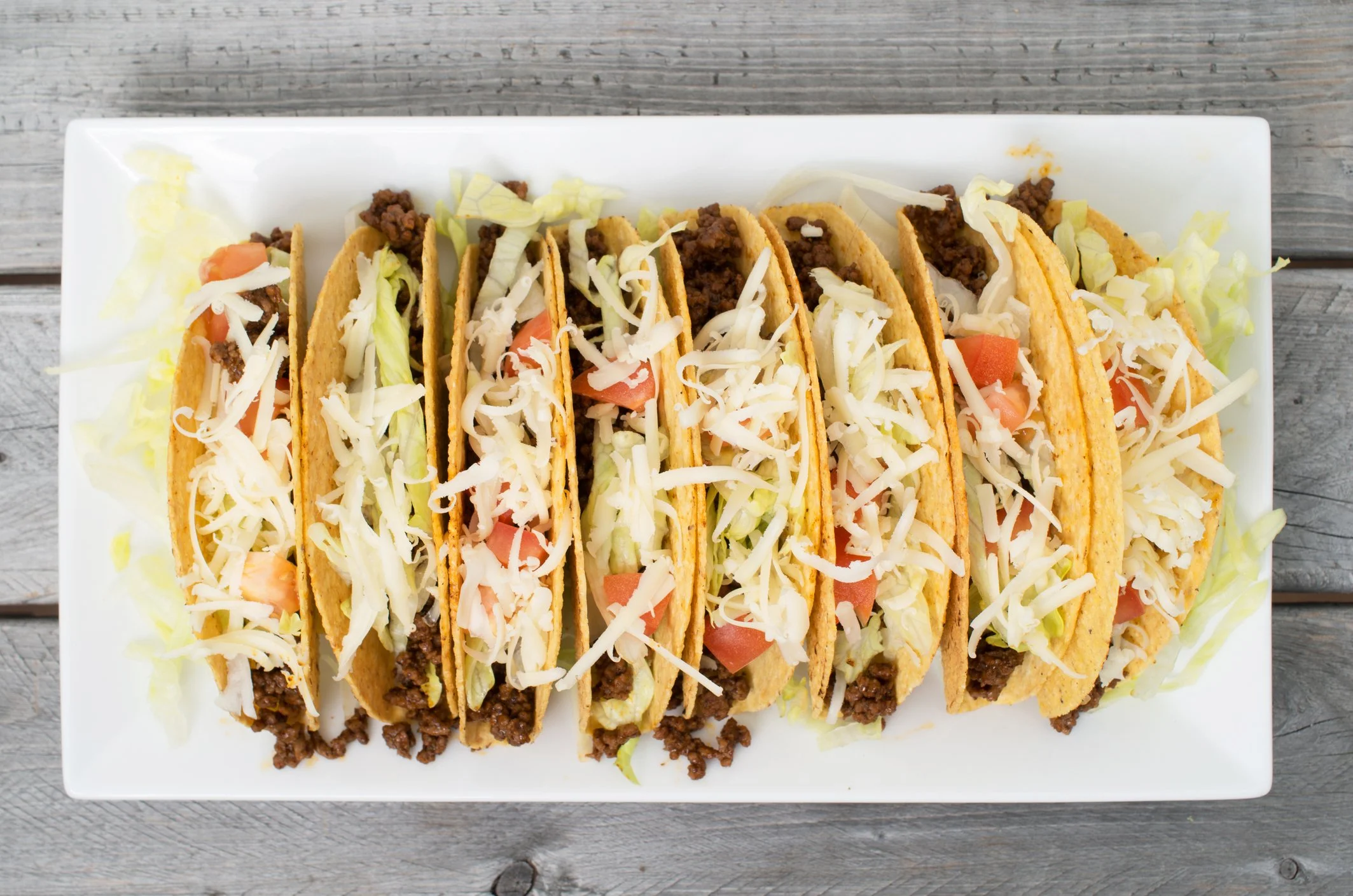 A platter of hard-shell beef tacos lined up in a row — the reward at the end of a 650-mile run across Europe.
