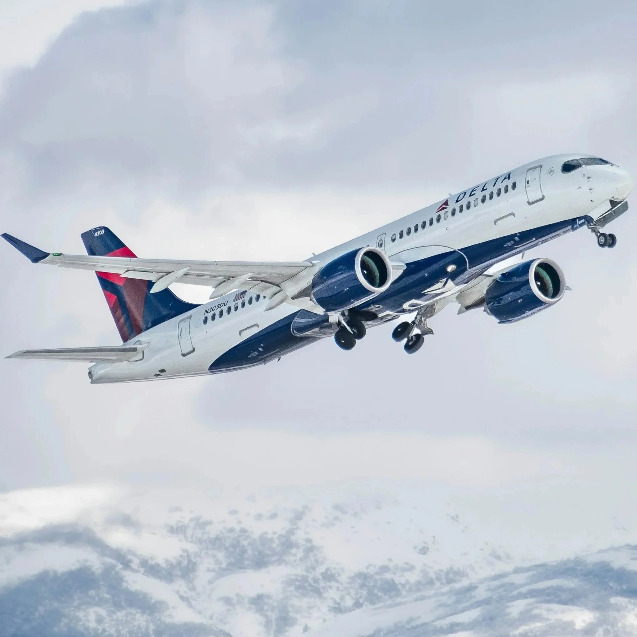 A Delta jet flying over snowy mountains — a visual echo of the constant winter travel during my Minnesota season.