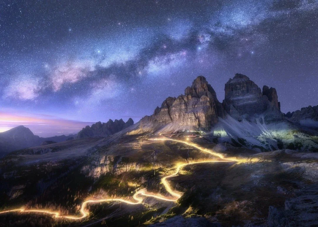 Desert mountain peaks under a vivid Milky Way with a glowing switchback trail, evoking the journey toward financial independence.