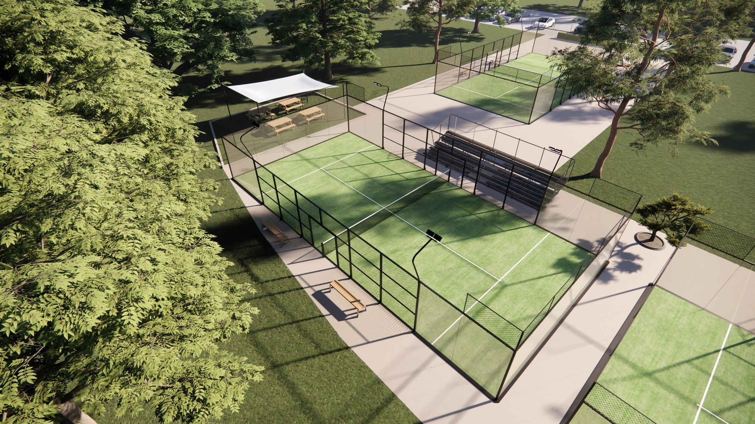 Luftaufnahme eines Padelcourts in einem Park mit Bänken, Bäumen und Parkplätzen im Hintergrund.