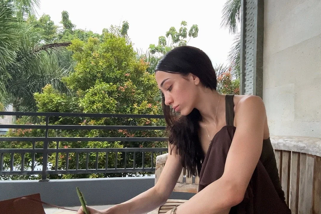 Rachael Ferrarese journaling outside.
