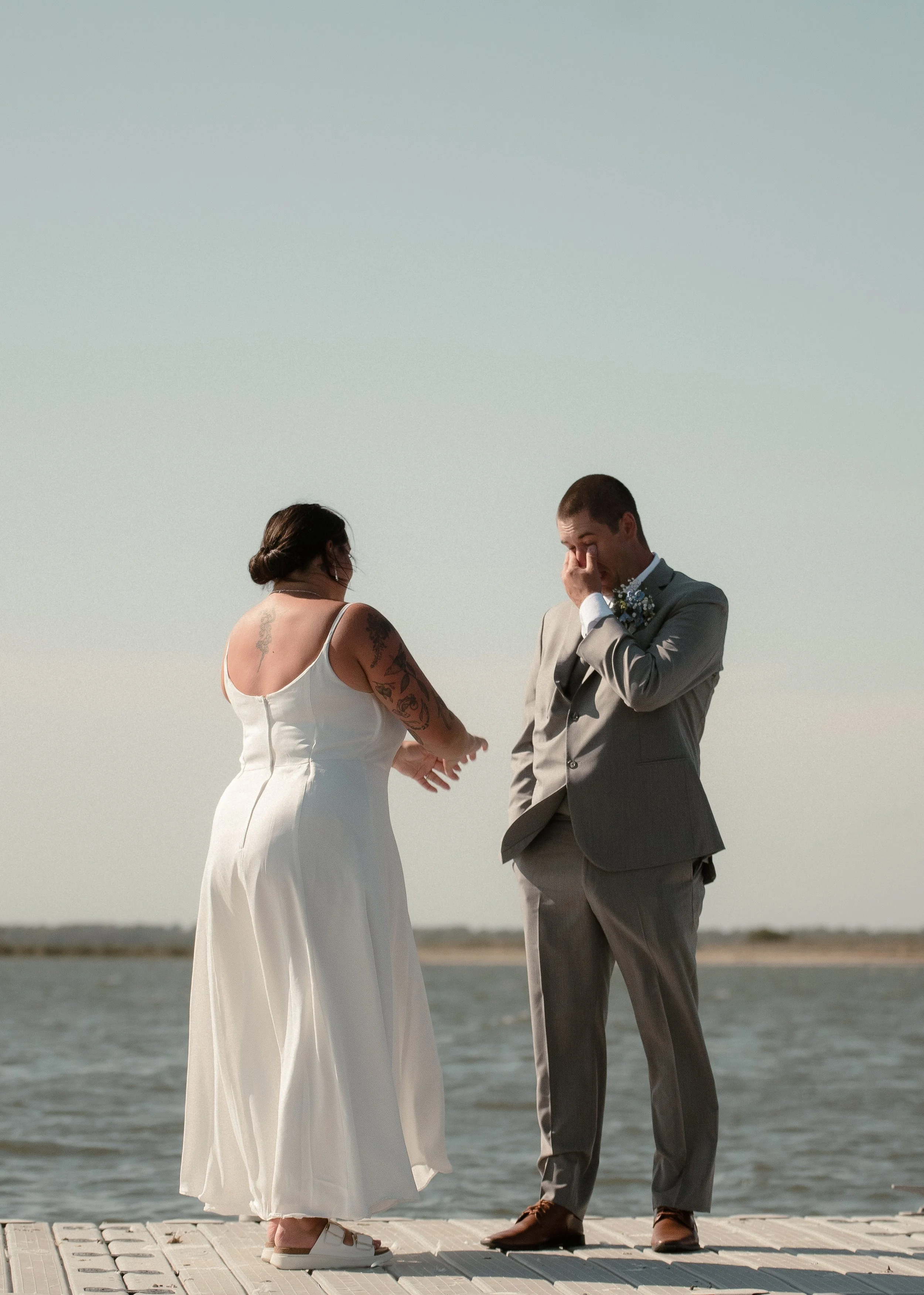Groom emotional reaction seeing bride — candid wedding photography