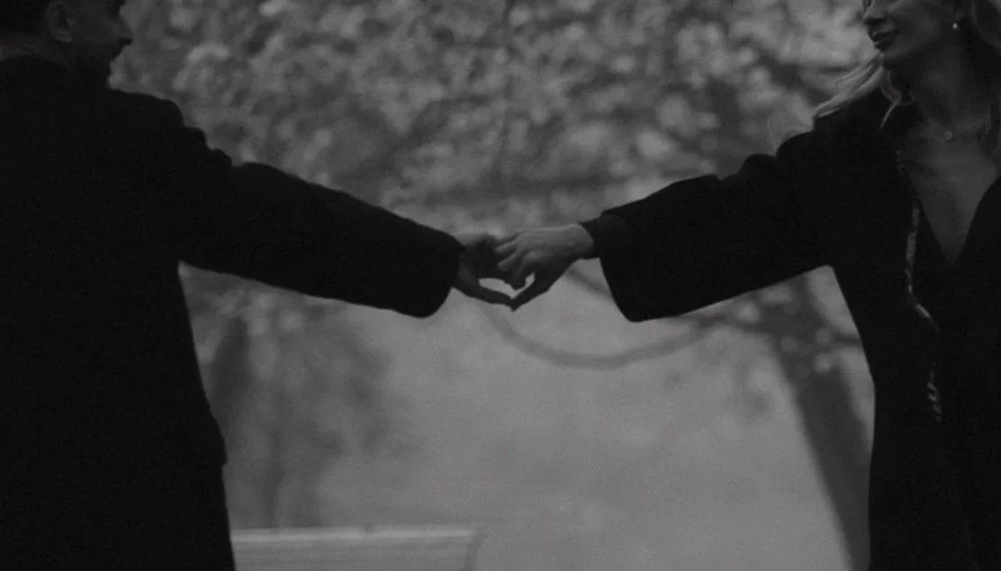 Couple holds hands in the shape of a heart