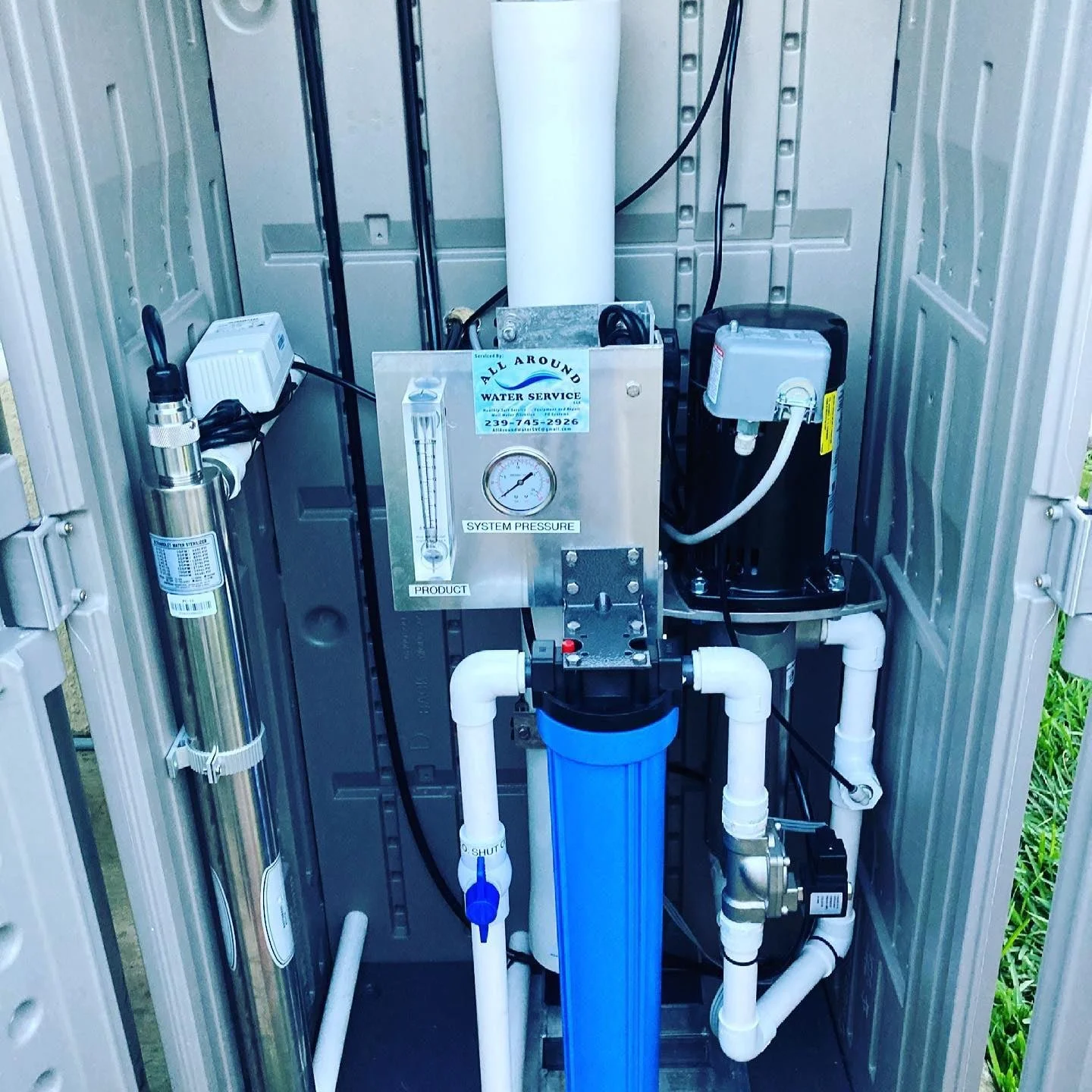 Image of a water treatment system with various pipes, gauges, and components inside a metal enclosure.