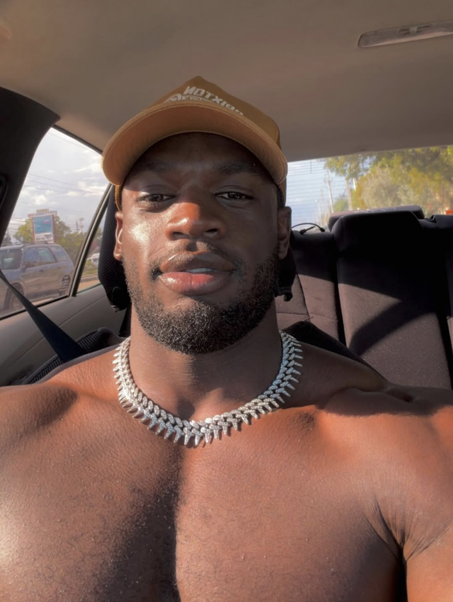 Dylan poses shirtless in a car