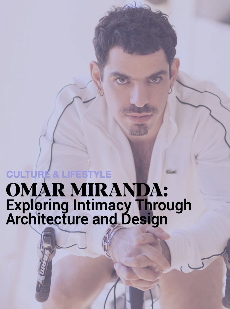 Portrait of Omar Miranda looking intensely at the camera, wearing a white jacket with black piping, featuring earrings, a bracelet, and a keychain hanging from his sleeve. The background is light and blurred, with text overlay about exploring intimacy through architecture and design.