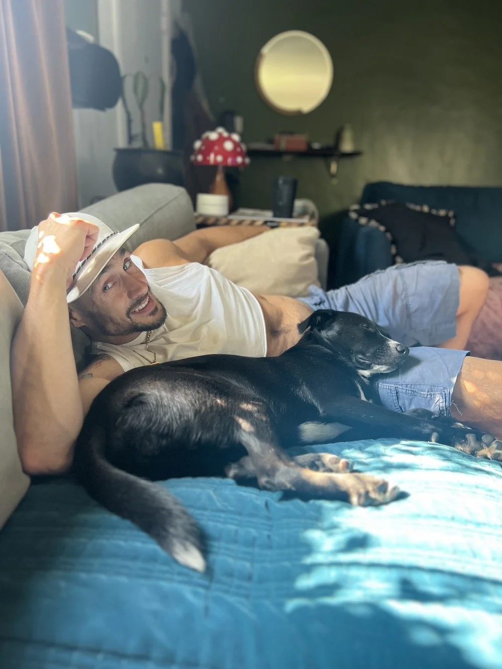 Wolfie lying on a bed with his dog