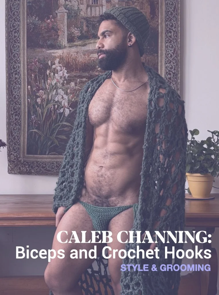 A shirtless man with a beard, wearing a knitted beanie and crochet underwear, stands indoors near a wooden table with a potted plant on it. There is a large framed painting of flowers and a landscape behind him.