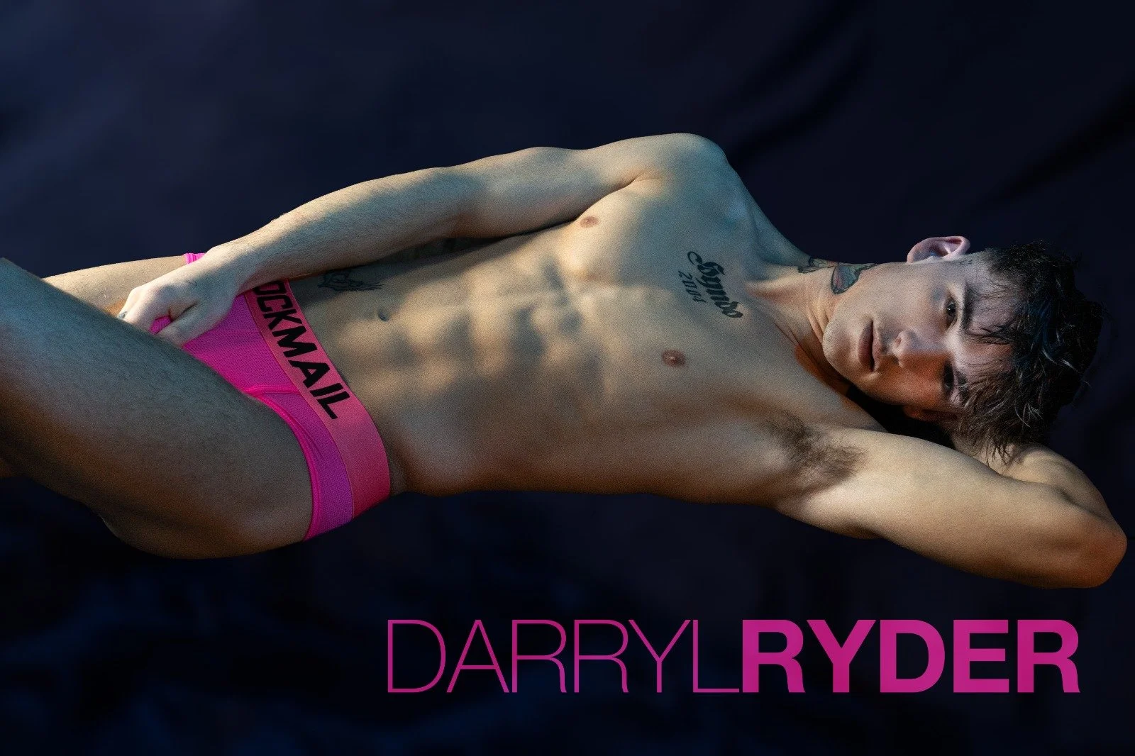 Darryl Ryder lying down and wearing a pink underwear