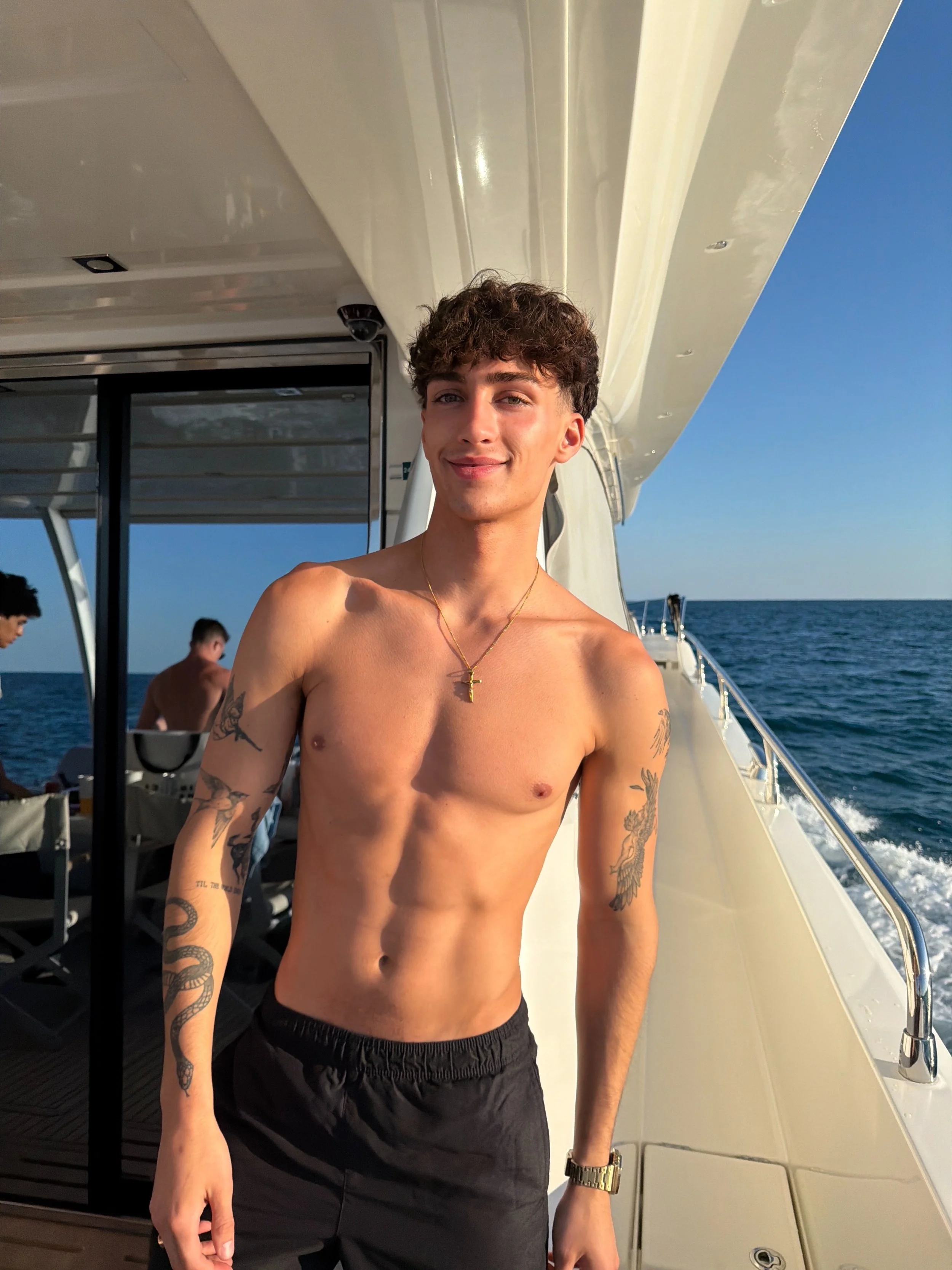 Chasexparkerr posing shirtless on a boat