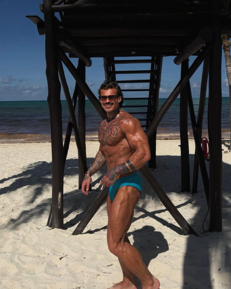Ethan-James on the beach wearing speedos