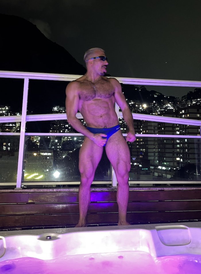 Boyca posing in his swimwear by the pool