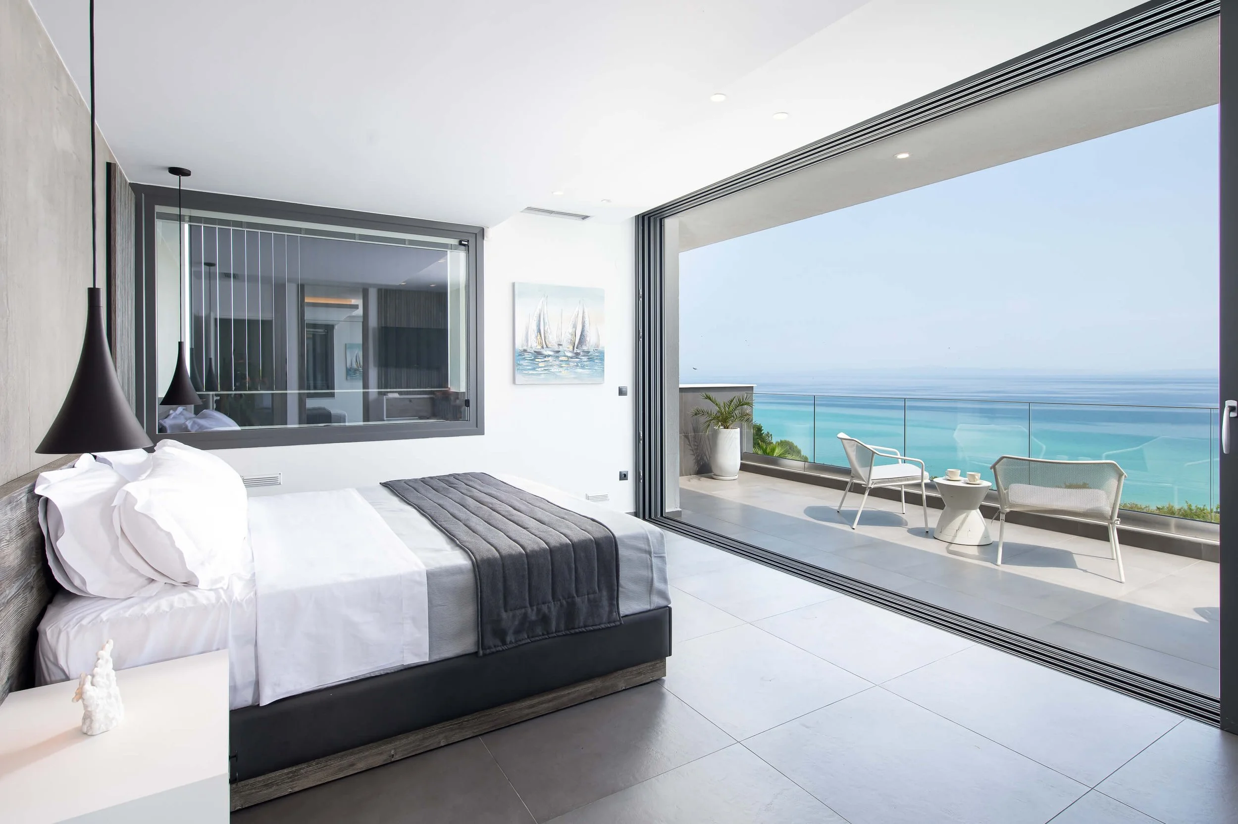 Master bedroom in Antonio Villa Halkidiki with king-size bed and sea-facing balcony