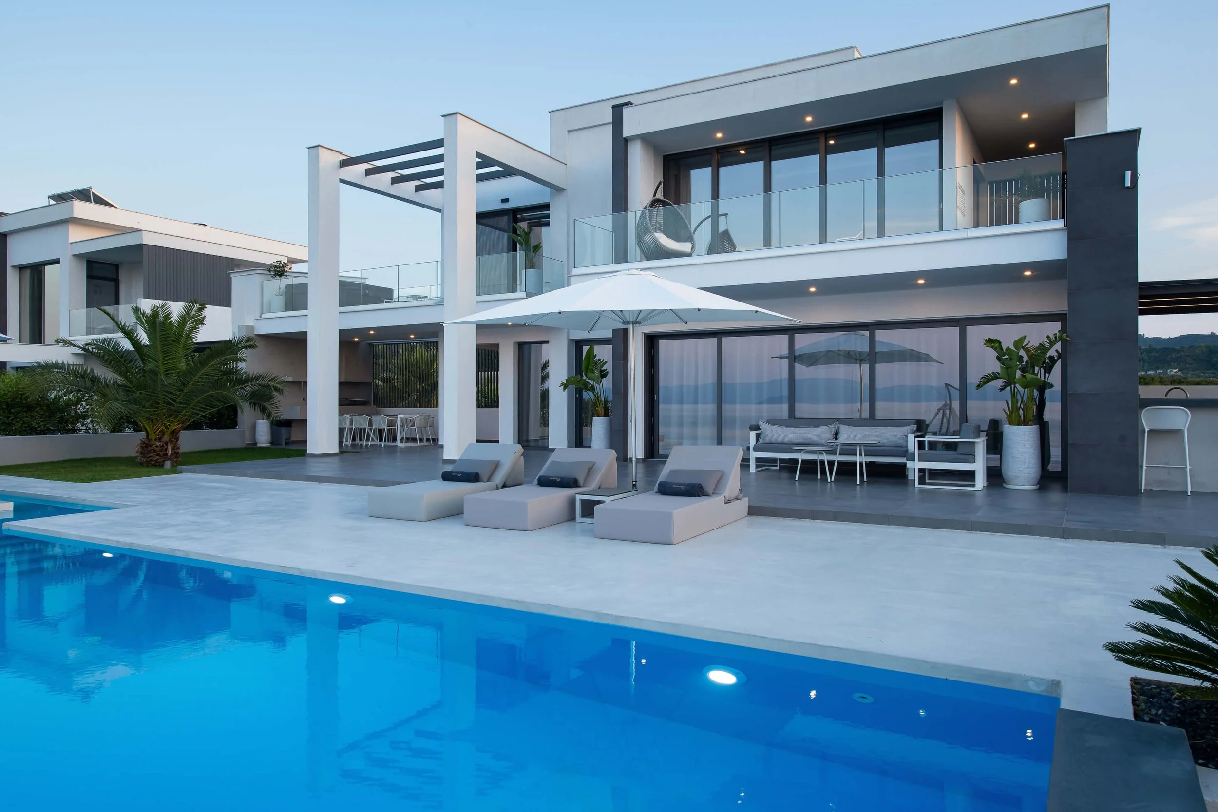 Daytime view of Antonio Villa private infinity pool and lush outdoor space Halkidiki