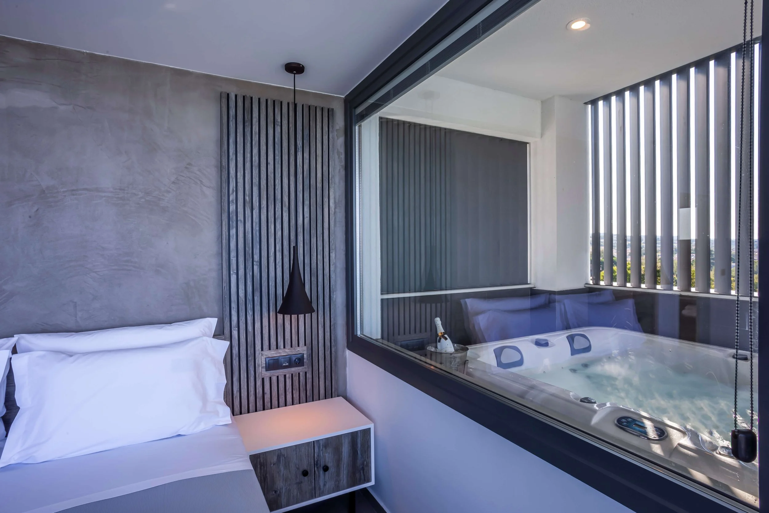 Master bedroom in Antonio Villa Halkidiki with Jacuzzi, king-size bed and sea-facing balcony