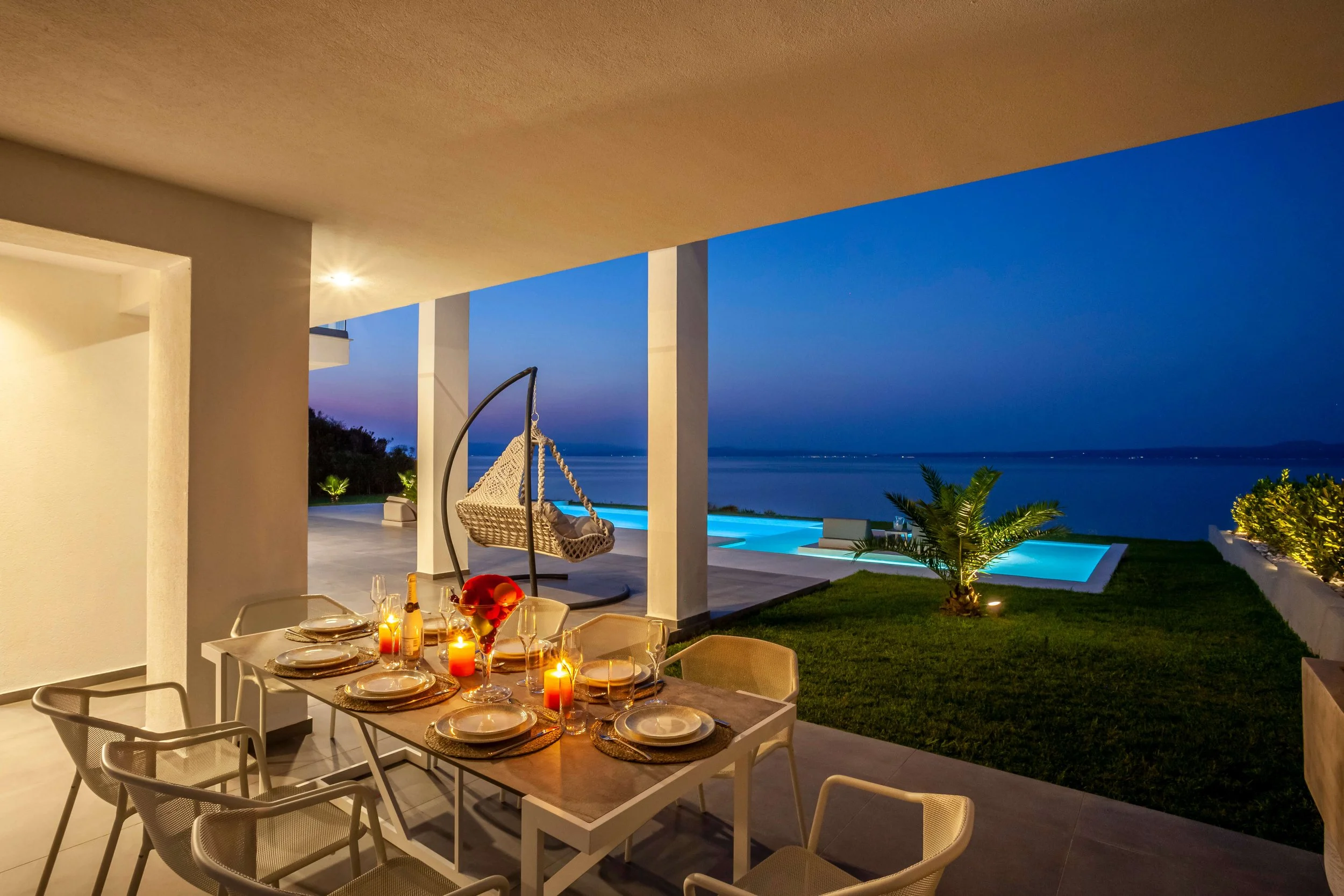 Elegant exterior bar and dining terrace of Antonio Villa with Mediterranean backdrop