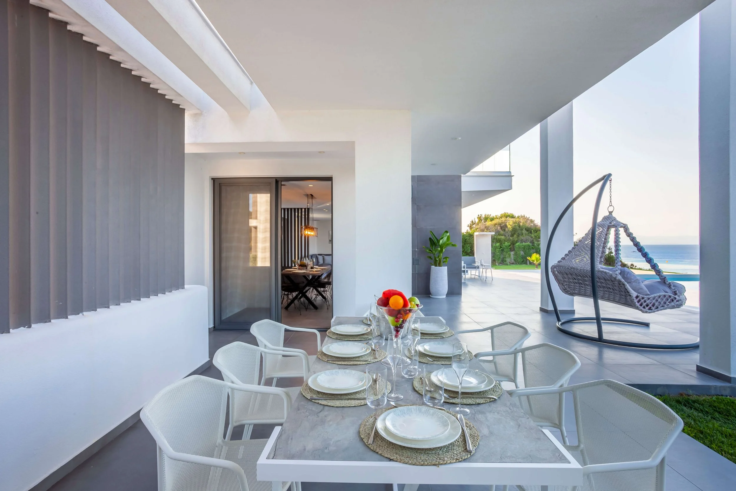 Antonio Villa outdoor dining area with bar counter and sea view seating Hanioti