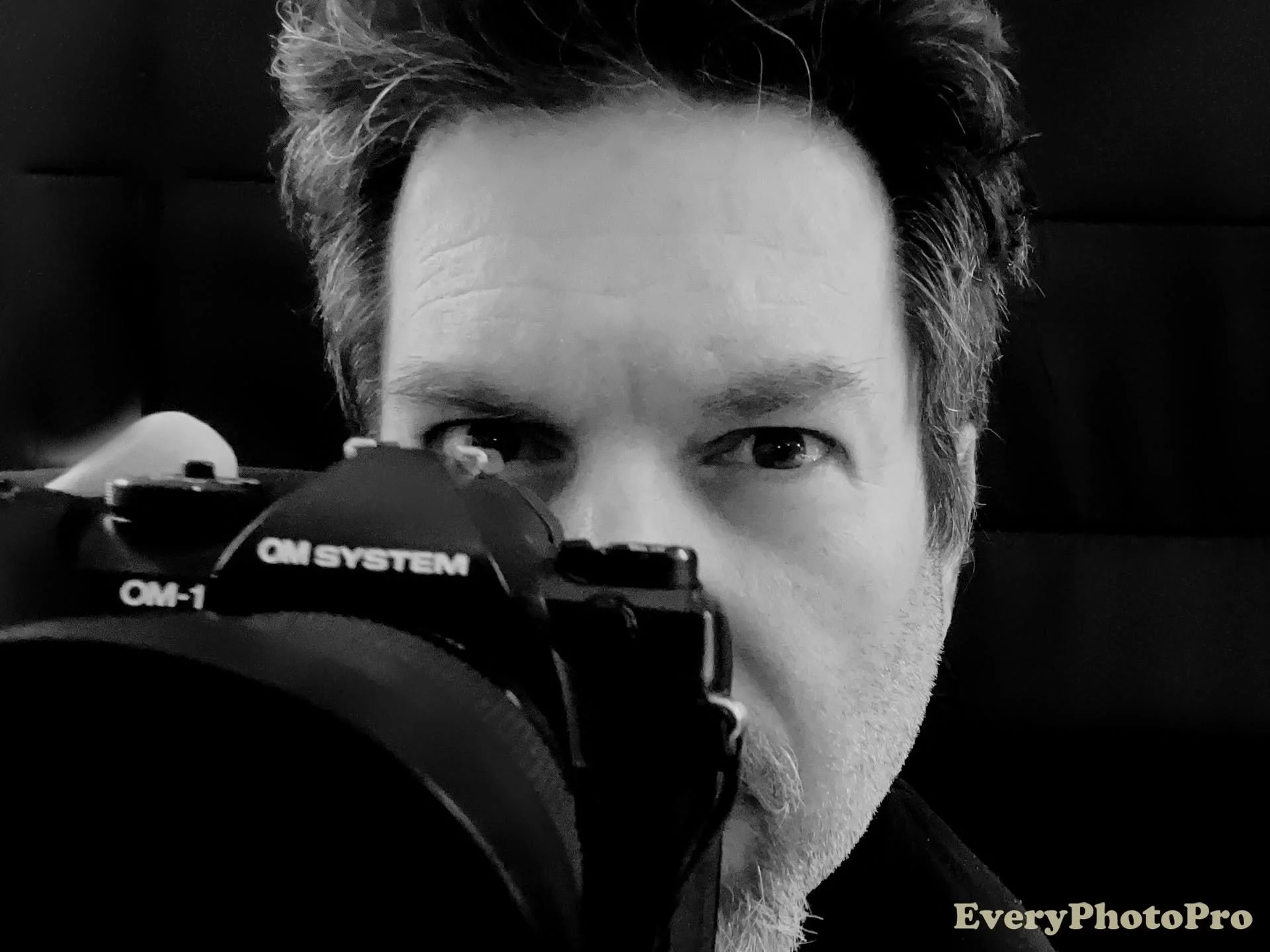 man with camera at his eye