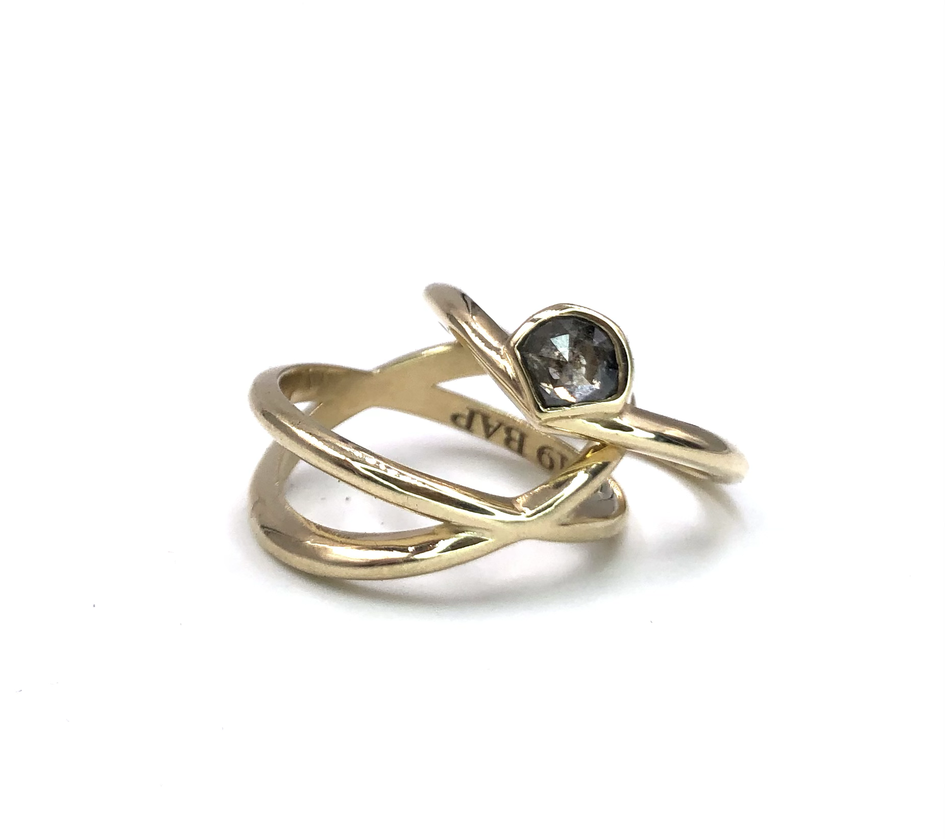 Two gold rings, one with a black gemstone, displayed on a white background.