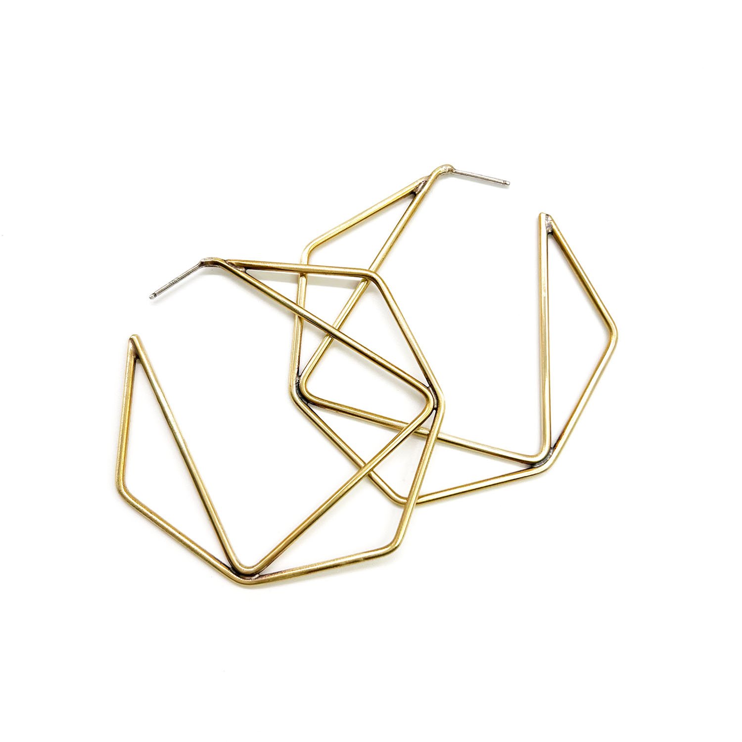 Collection of gold-colored metal geometric jewelry pieces on a white background.