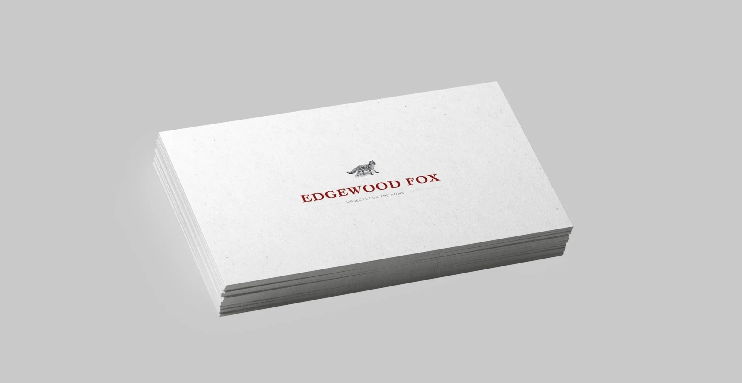 Stack of white cards with a logo of a fox and the text "Edgewood Fox" in red, along with a description "Objects for the home" in smaller gray font.