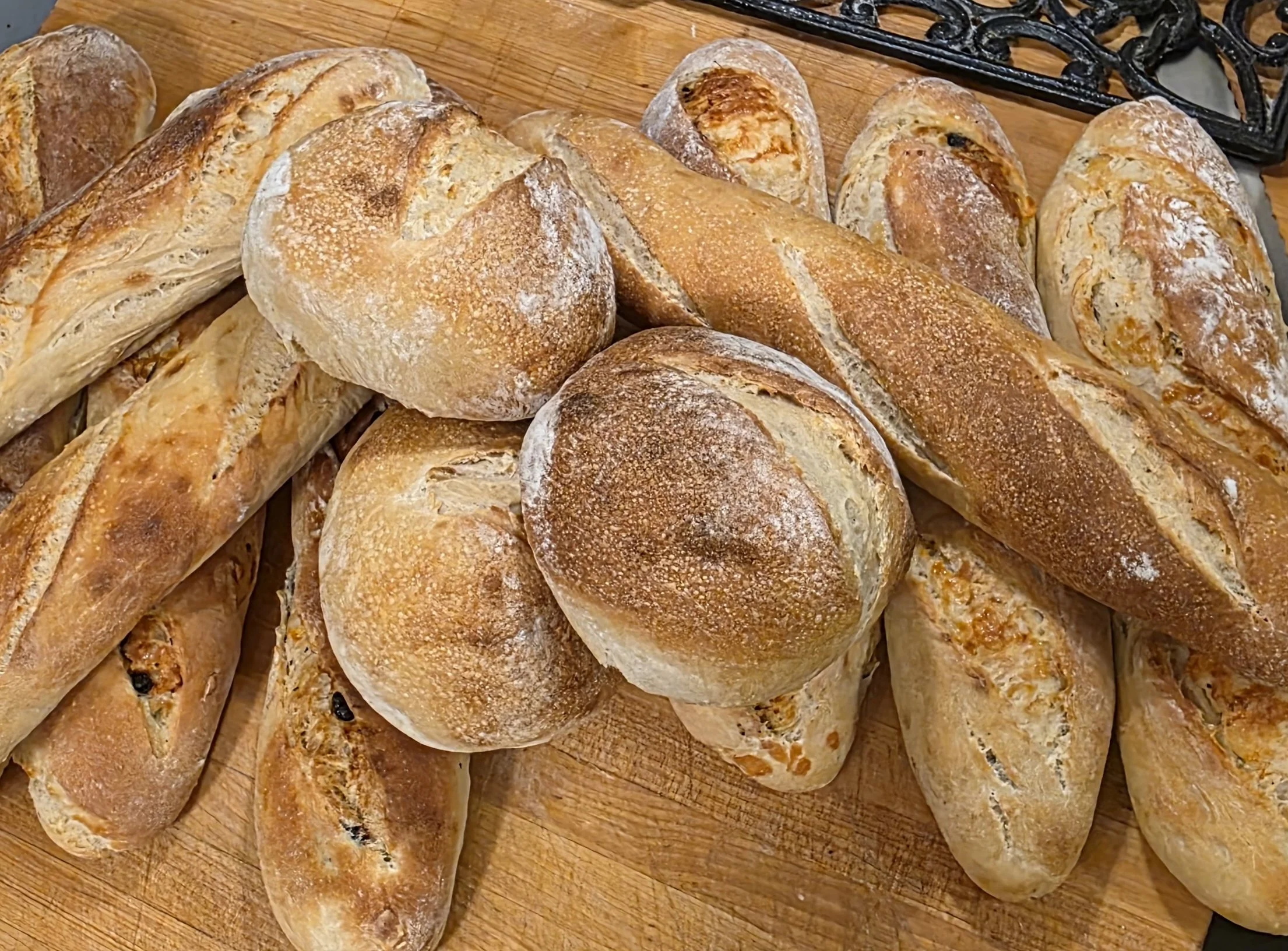 A variety of freshly baked bread loaves and rolls.